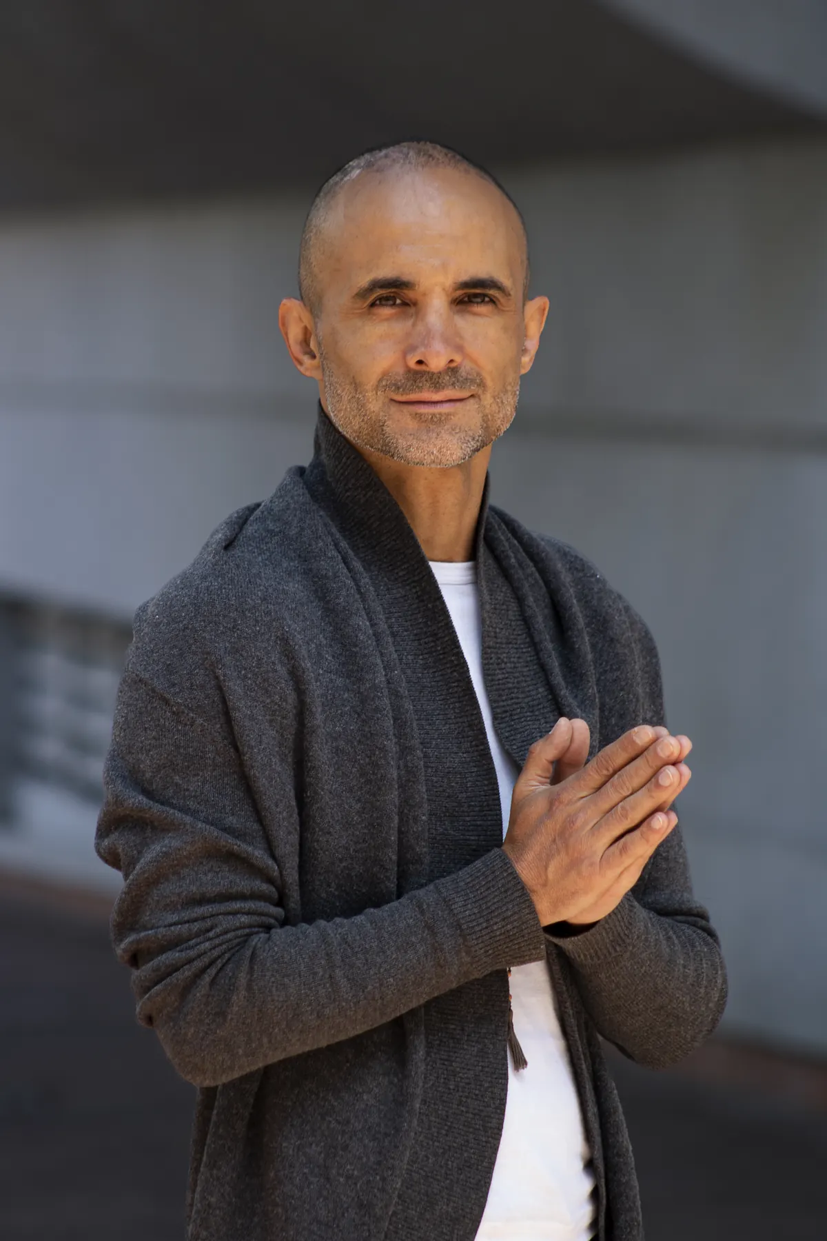 Portrait of Andrei Ram with his hands together