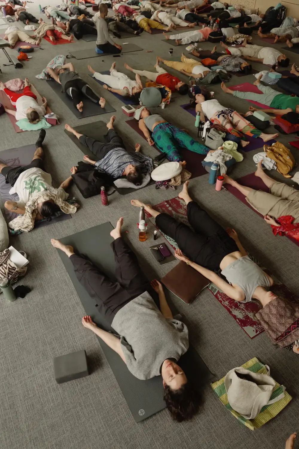 A group lying on the floor during a prana nidra practice guided by Andrei Ram